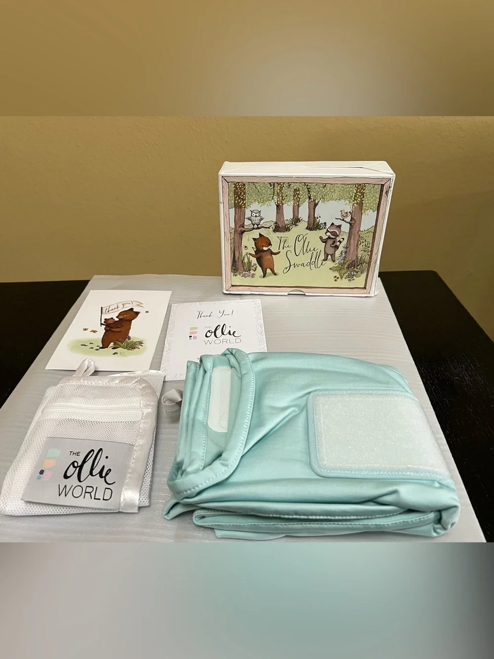 The Ollie Adjustable Swaddle For Newborns. Color: Sky. NEW IN OPEN BOX